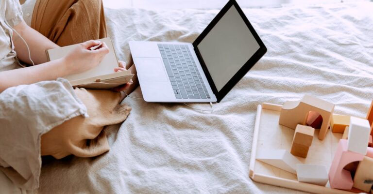 Calendário de conteúdo com laptop e smartphone, planejando divulgação científica sem exageros.