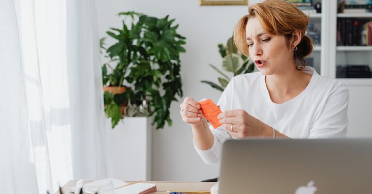 mesa com calculadora, moedas e lista de despesas, ilustrando planeamento financeiro da bolsa