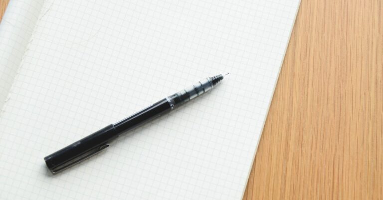 Pesquisadora escrevendo código-book em notebook com categorias temáticas definidas claramente.