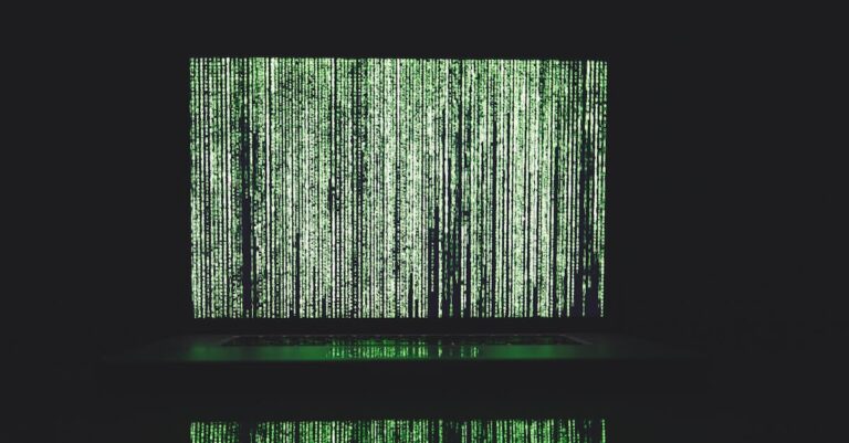 Pesquisador examinando matriz de dados qualitativos em tela de computador com tabela de códigos e ocorrências.