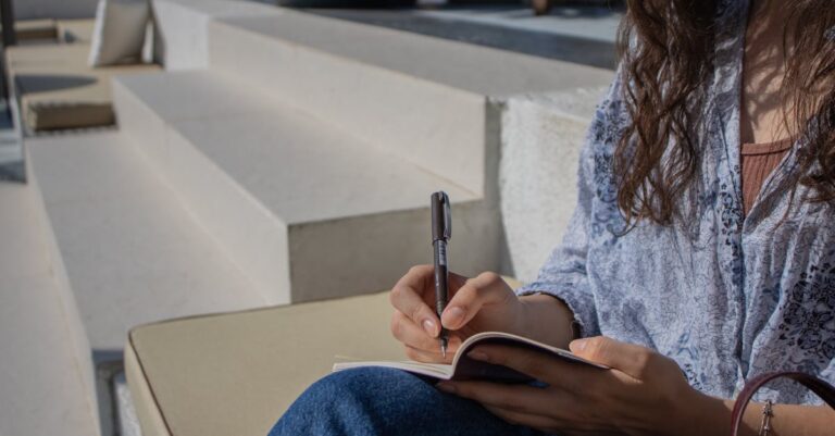 Mulher escrevendo passos em notebook com foco e fundo limpo