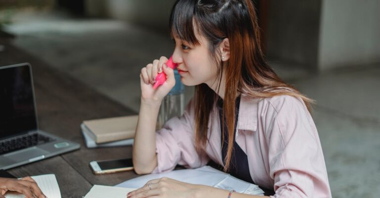 Estudante pesquisador analisando perfil e notas em laptop com iluminação natural