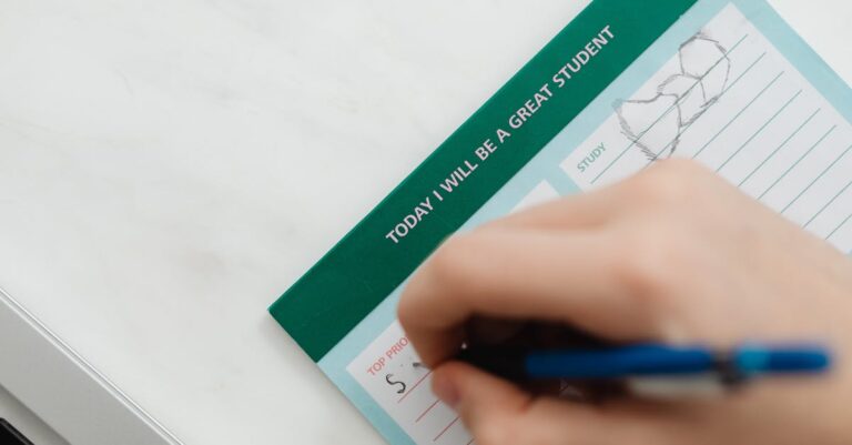 Mão escrevendo metas específicas em planner com detalhes minimalistas.